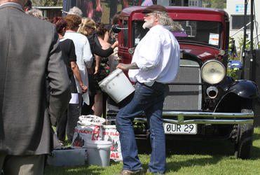Mourners lined up to take a piece of coal and place it in the tray of the vintage Whippet truck - registration number: Our 29.