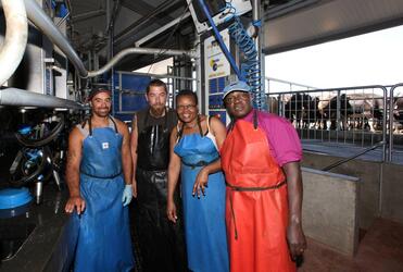 Archbishop John and Mrs Margaret Sentamu kitted up to supervise the afternoon milking at Faull Farms Super Shed.