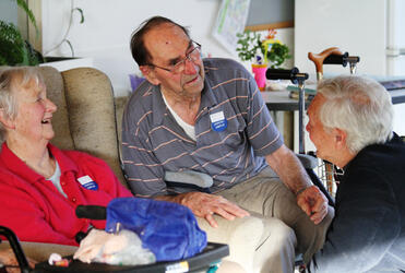 Canon Brian Thomas shares some good memories with two of the residents, as they waited for their bus.