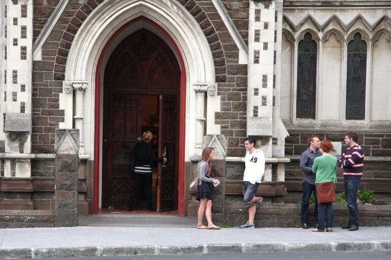 Mathew Newton (blue shirt) catches up with folk arriving for the 6.30pm Sunday service at St Paul's Symonds St.