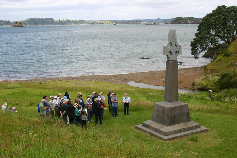 Conference-goers gather before the Marsden Cross at Oihi.