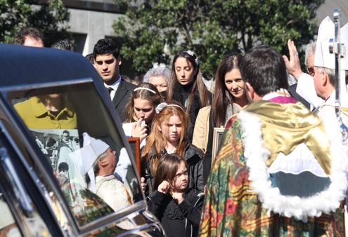 Archbishop David pronouces a blessing over the Reeves family, as the hearse prepares to leave the cathedral forecourt.