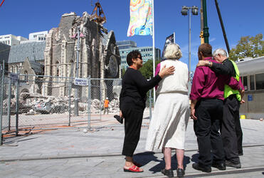 Mrs Helen Gray, Bishop Victoria Matthews, Bishop John Gray and Dean Peter Beck support each other as the tower is made safe.