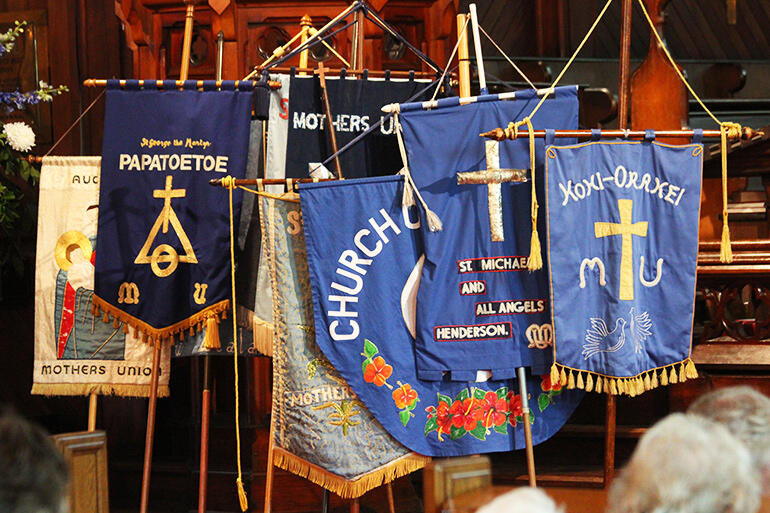 For the duration of the lecture, the banners of various parish branches stood sentinel at the front of the church.