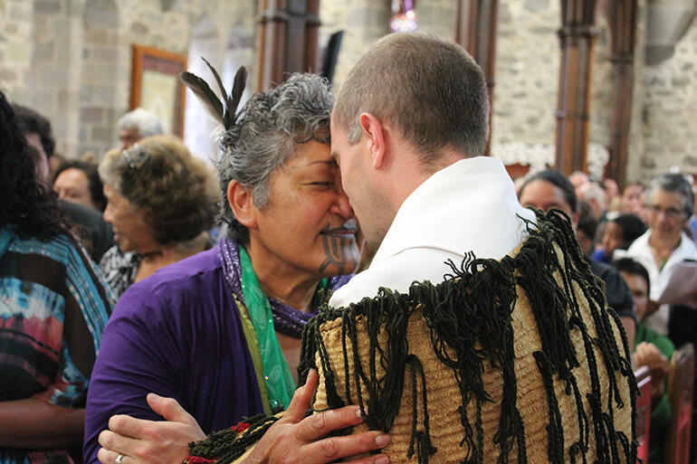Taranaki matriarch Maata Wharehoka acknowledges Dean Jamie Allen after the removal of the cathedral’s military hatchments in March 2013.