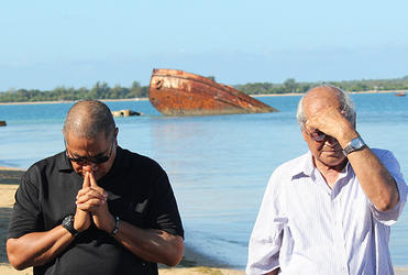 One of the staff at Pangaimotu joins Archbishop Brown Turei during morning lotu.