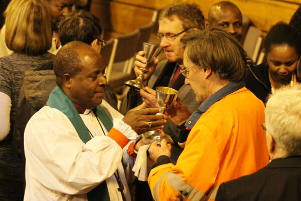 Bishop James Ligo of Vanuatu serves the chalice during the final conference Eucharist.