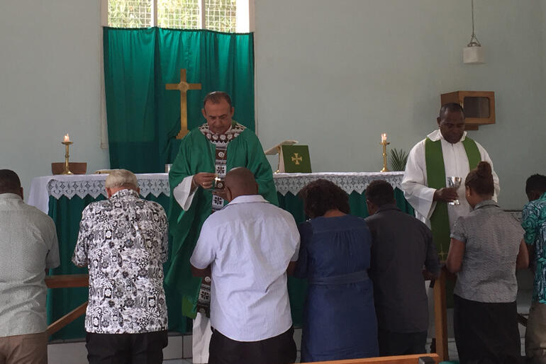 Bishop Gabriel Sharma and Rev Jioji Abonio serve holy communion at St Christopher's in Nadi, Fiji.