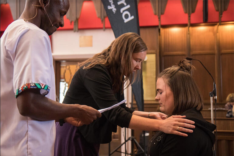 Bishop Eleanor Sanderson and Steve Maina pray for Anna Smart as she heads into the Better World gap year.