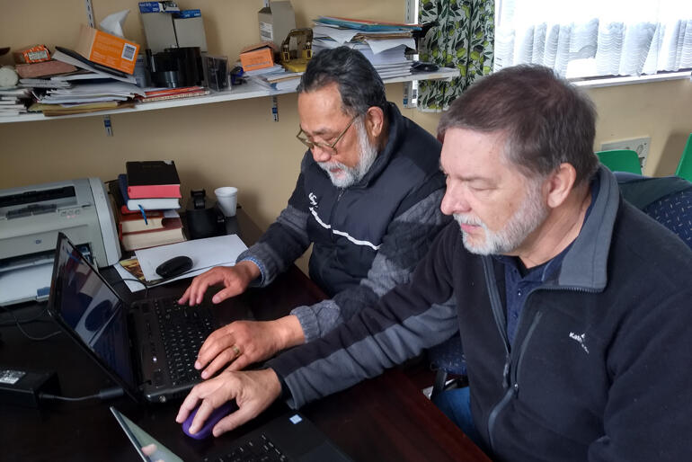Lead Translator Ioane Teao and NZ Bible Society Translations Director Dr Stephen Pattemore check the final Tokelauan Bible translation.
