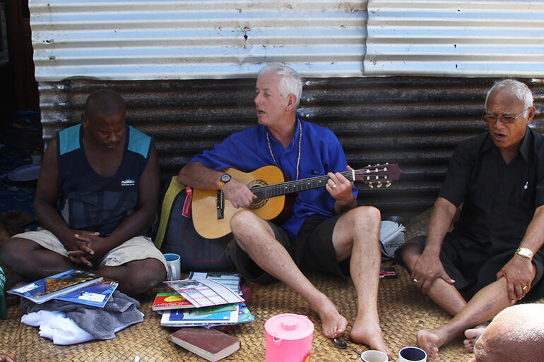 Mike Hawke leads impromptu worship at Maniava, a couple of weeks after it was flattened by Cyclone Winston.