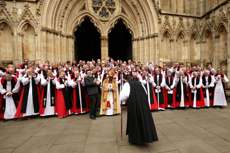 The first female bishop in the Church of England, Libby Lane, bows to her fellow bishops following her consecration service at York Minster. 