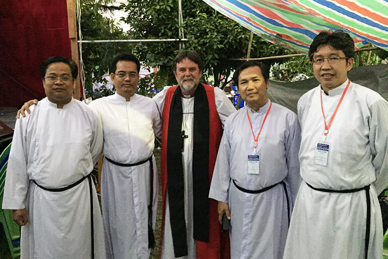 Archbishop Philip flanked by the Evensong team at the gathering.