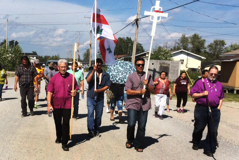 Bishop Ngarahu Katene and Robert Kereopa walk with Bishop Mark MacDonald and people of the Indigenous Spiritual Ministry of Mishamikoweesh.