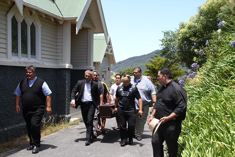 The pallbearers take Archbishop Brown from St Mary's.