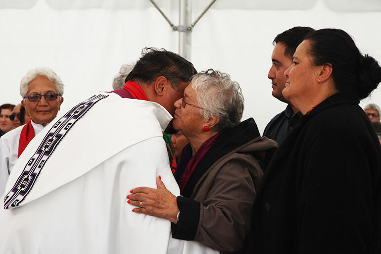 Whaea Mihi blesses the new bishop of Te Tairawhiti, with her daughter Jan and grandson Nehe in support.