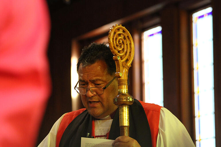 Bishop Kito behind the shoulder of one of his Anglican Maori Club choir members.