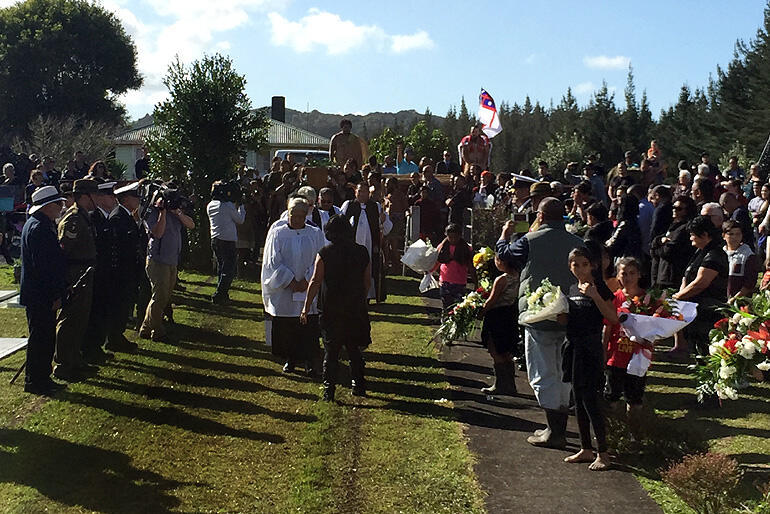 Mourners carry Sir Graham toward his final rest at Tarakaka Urupa, Pamapuria.
