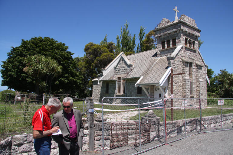 Bishop Richard and Awatere parishioner Malcolm Taylor take notes on the future of red-cordoned St Oswald's Anglican Church south of Ward.