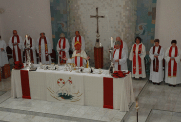 Newly ordained priests join Bishop Tom behind the altar. Photo/Jay Berryman  