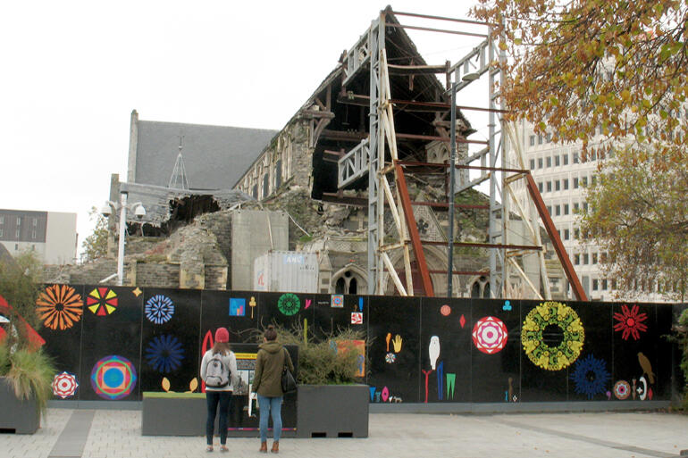 ChristChurch Cathedral stands behind hoardings in the square, April 2017.