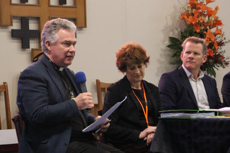 Dean Lawrence Kimberley talks to synod flanked by Suzanne Price and Richard Seville from CPT.
