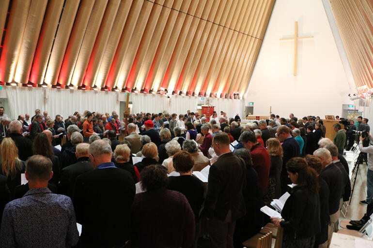 Synod members stand to sing during this year's Synod Eucharist at the Christchurch Transitional Cathedral.
