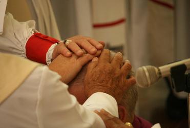 The moment of ordination: the Archbishops and Bishops lay their hands on the candidate.