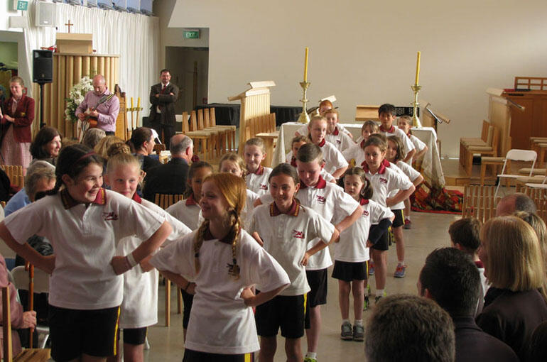 Children from St Mark’s School perform a dance after the service in honour of Lawrence’s contribution as chaplain.