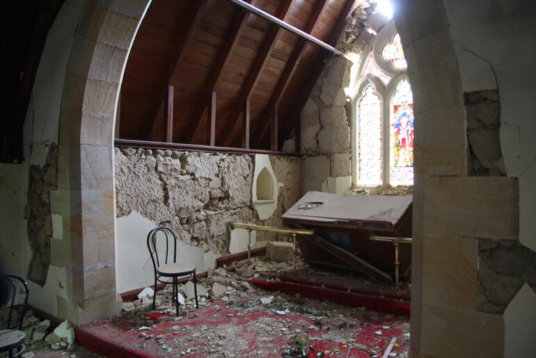St Cuthbert's, Governors Bay - falling masonry has toppled the altar, and the stained glass window is in jeopardy.