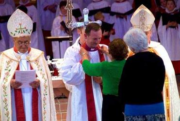 A pectoral cross is placed around the neck of Auckland's 11th bishop, Ross Bay. Picture, Simon Woolf.