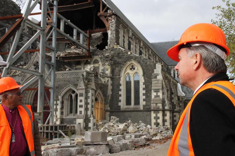 Archbishops David Moxon and Winston Halapua check out the ruins of ChristChurch Cathedral during the bishops' tour of the red zone.