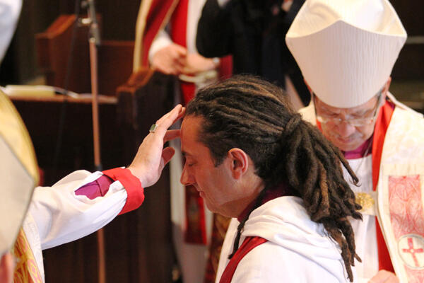 Archbishop David anoints the forehead and hands of the newly ordained bishop.