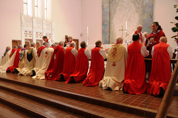 Bishop Justin distributes the host to his fellow bishops.
