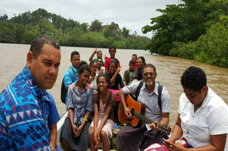 Bishop-elect Henry Bull (with the guitar) doing what he loves best - going on mission - in the territory he loves best.