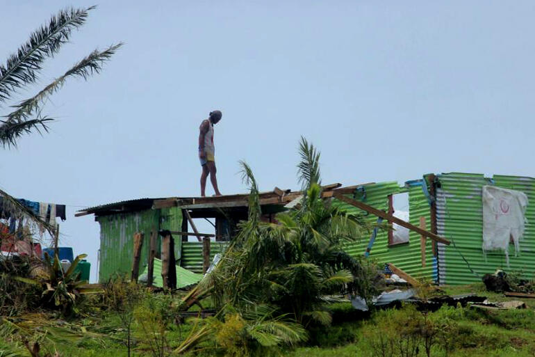 Fiji: Man assesses damage to roofing in the aftermath of Cyclone Winston. Source: Fiji Government.