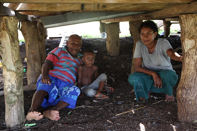 Mosese Kakaramu lies among the pilings of his house, where eight members of his family sought shelter from the storm.