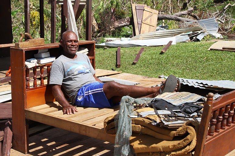 Waisake Raikadroka finds reason to keep smiling: his bed survived the Maniava maelstrom more or less intact.