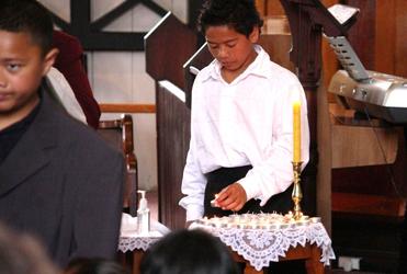 Lighting a candle for tsunami victims.