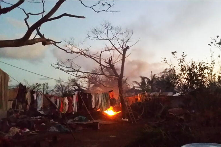Twilight burning of the rubbish strewn about by Cyclone Pam.