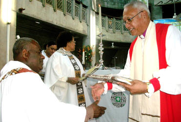 Archbishop Winston congratulates Fr Demesi, one of the clergy who went through the non-violence workshops. 