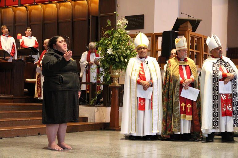 Kaikaranga Tepora Priest calls as Bishop-elect Ana enters the Cathedral with her procession of whānau and supporters.