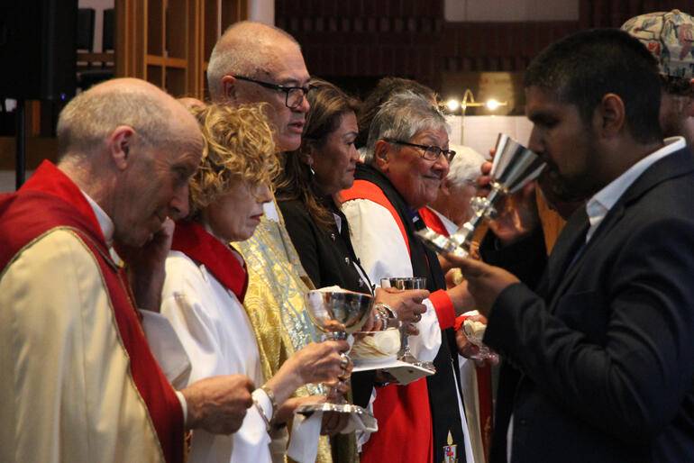 Worshippers share in holy communion.