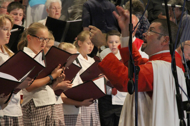 Dr John Linker directs the combined parishes and Anglican schools' choir.