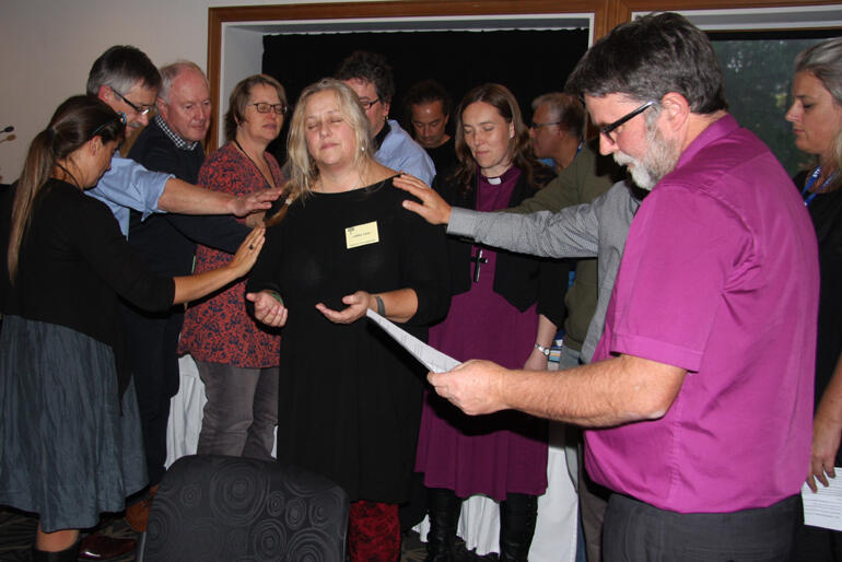 Archbishop Philip Richardson prays for Lorna Gray in her new leadership role, joined by supporters in diocesan and national roles.