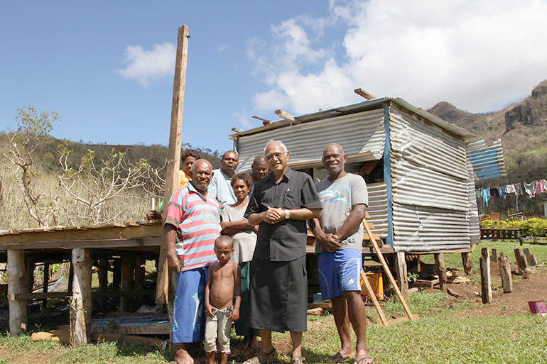 Flashback to March 2016: Archbishop Winston and Mosese Kakaramu outside what was left of his home.