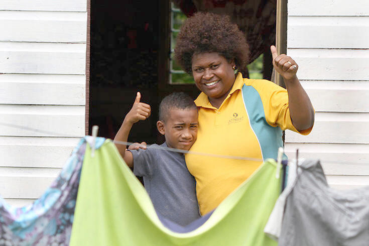 Teni and son at their front doorstep.