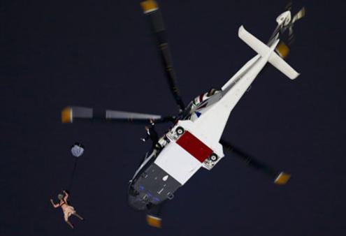 Actors portraying the Queen and James Bond arrive via parachute during the Olympics opening ceremony. Photo: Reuter