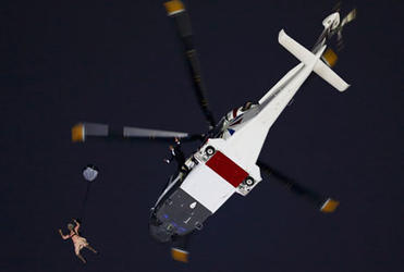 Actors portraying the Queen and James Bond arrive via parachute during the Olympics opening ceremony. Photo: Reuter