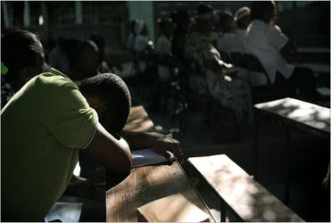 Haitians seek solace amid the ruins of Port-au-Prince.